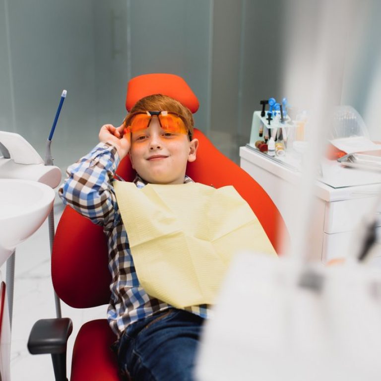 Boy satisfied with the service in the dental office. concept of pediatric dental treatment